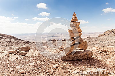Several small stones placed one on another standing in a park of stones in the Judean Desert near the city of Mitzpe Ramon in Isra Stock Photo