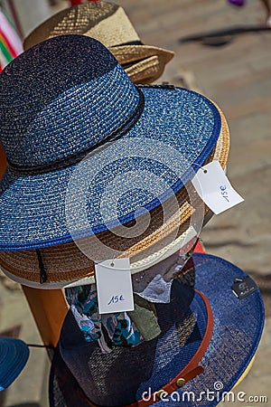 several straw hat stacked in front of a merchant shop Stock Photo