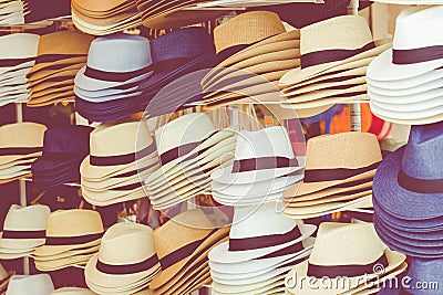 Several straw hats in a flea market Stock Photo