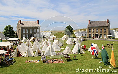 Several tents set up on lawn with stone buildings beyond, Fort Ontario, New York, 2016 Editorial Stock Photo