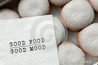 Several traditional german donuts with powdered sugar and a napkin on top. Top view. Good food, good mood. Stock Photo