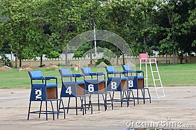 Several wooden chairs with numbers on outdoor, competitive exam concept Stock Photo