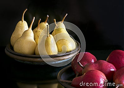 Several yellow and red pears in bowls Stock Photo