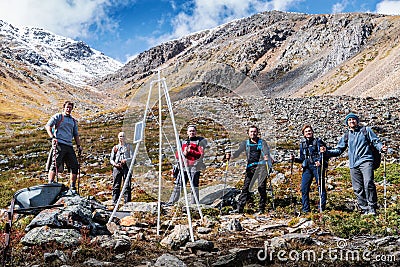 Tourists-photographers on a halt on a mountain slope Editorial Stock Photo