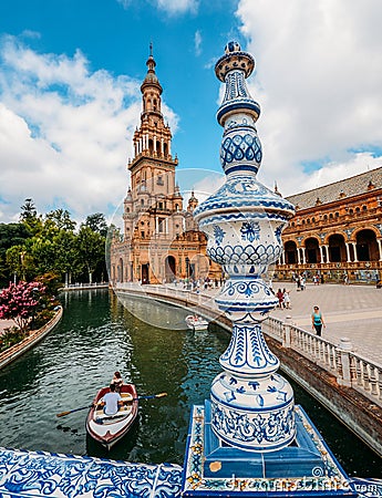 Juxtaposition of blue and white ceramic azulejo tiles against one of the baroque sandstone tower at Plaza de Espana in Seville, Sp Editorial Stock Photo