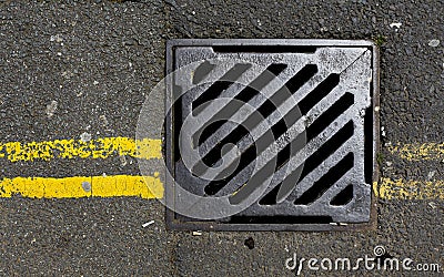 Sewer cover with double yellow lines Stock Photo