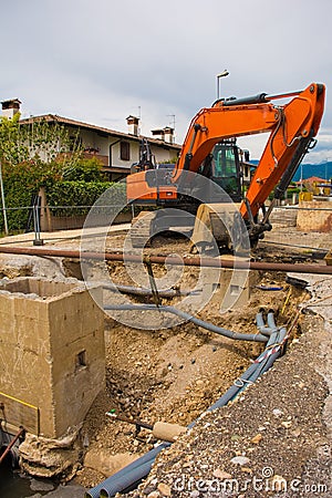 Sewer Well and Crawler Excavator Stock Photo