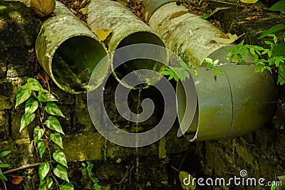 Sewerage pipes located at the forest at the tropical island Stock Photo