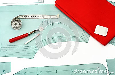 Sewing background. Sewing accessories and fabric on a paper pattern. Stock Photo