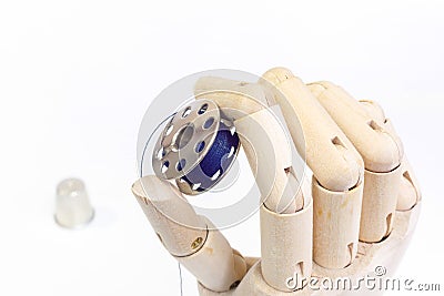 Sewing bobbin in wooden hand Stock Photo