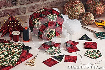 Sewing christmas decoration ball, fabric pieces, sewing accessories, traditional patchwork Stock Photo