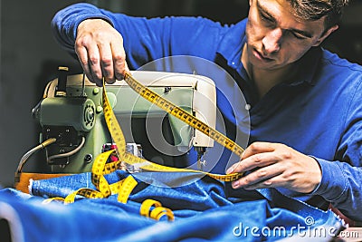 Sewing denim jeans with sewing machine. Repair jeans by sewing machine. Alteration jeans, hemming a pair of jeans, handmade Stock Photo