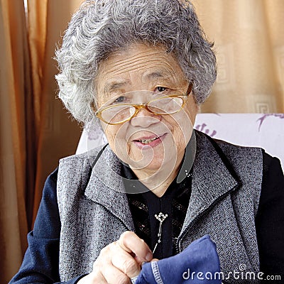 Sewing grandmother Stock Photo