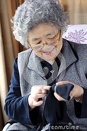 Sewing grandmother Stock Photo