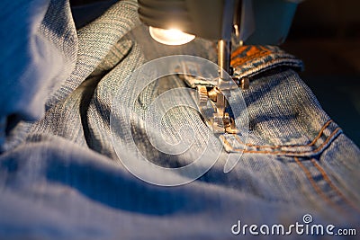 Sewing jeans. Stock Photo