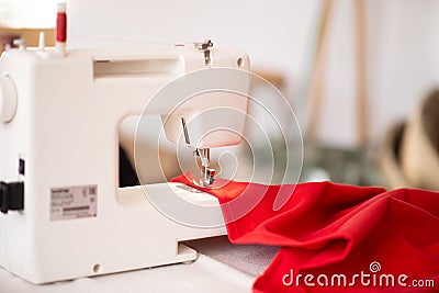 Sewing machine with red cloth closeup. sewing process in the re-stitching phase Stock Photo