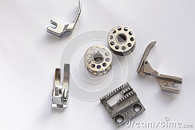 sewing machine steel yarn, bobbin for thread and other tools or parts on white background Stock Photo