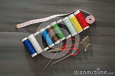 Sewing needle and colored spool yarns, multicolored spool yarns, sewing and sewing needles, scissors and scissors, tailoring mater Stock Photo