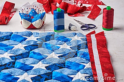 Sewing of quilt with stylized elements of American flag Stock Photo