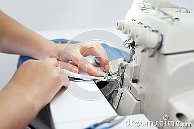 Sewing room, seamstress sews clothes on a sewing machine Stock Photo