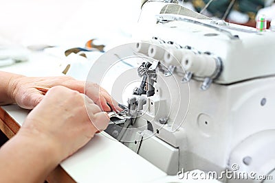 Sewing room, seamstress sews clothes on a sewing machine Stock Photo