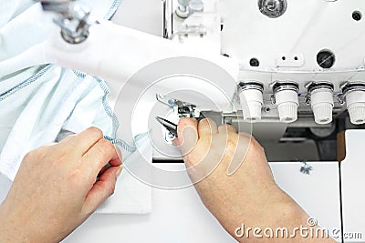 Sewing room, seamstress sews clothes on a sewing machine Stock Photo