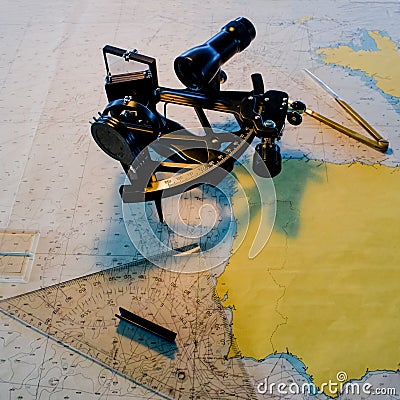 Sextant with a nautical chart in the captain`s cabin Stock Photo