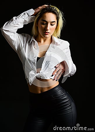 Sexual fetish concept. Portrait of sexy woman on black background. Wearing his shirt. Perfect body shapes. Sensual model Stock Photo