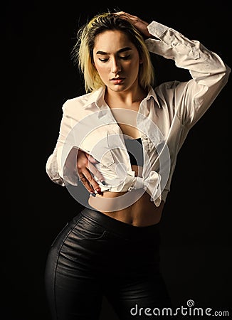 Sexual fetish concept. Portrait of sexy woman on black background. Wearing his shirt. Perfect body shapes. Sensual model Stock Photo