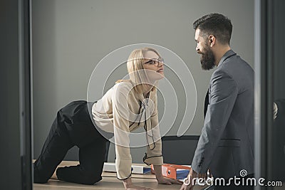 Sexual flirt at work. secretary seduce boss in office. Businesswoman on desktop look at bearded businessman. Man Stock Photo