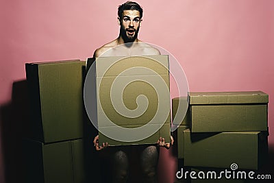 Sexuality and moving concept. Loader with shocked face covers nudity Stock Photo