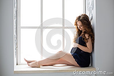 Sexy beatifull pregnant woman at black dress Stock Photo