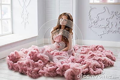 Sexy beatifull pregnant woman at pink dress Stock Photo