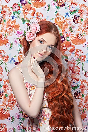 beautiful redhead girl with long hair. Perfect woman portrait with a colored light background. Gorgeous hair and deep eyes Stock Photo