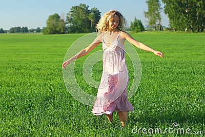 blond european girl relax in green summer meadow. Sunset in summer nature Stock Photo