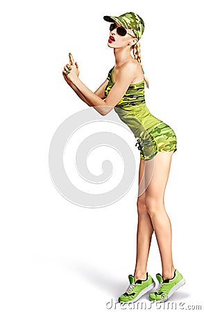 Fashion woman camouflage clothes doing gun gesture Stock Photo