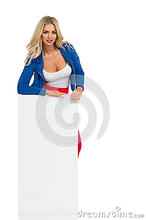 Blond Woman Is Standing Behind White Poster Stock Photo