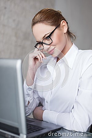 blonde businesswoman online flirt in office Stock Photo