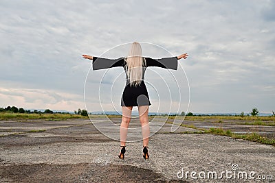 Sexy blonde in a mini skirt on runway Stock Photo