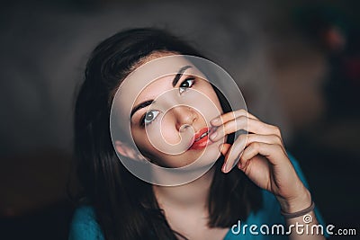 Sexy brunette dark eyes young women girl sitting at home touching lips looking camera sensual close-up Stock Photo