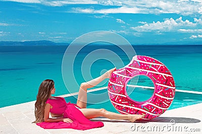 brunette Girl relaxing with inflatable float ring by the ho Stock Photo