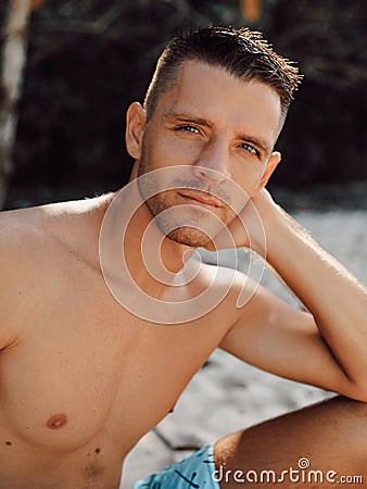 Sexy portrait of handsome topless male model on the beach Stock Photo