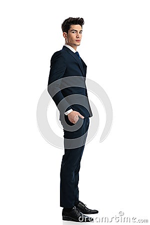 sexy confident businessman holding hands in pockets and standing in line Stock Photo