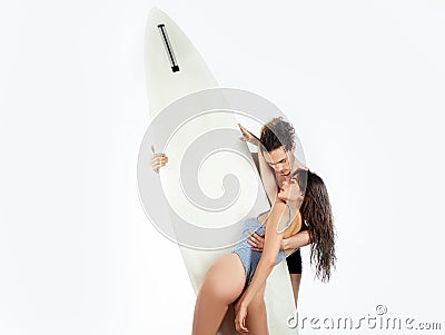 Sexy couple with surfboard. Happy sensual couple surfers going together to surf. Stock Photo