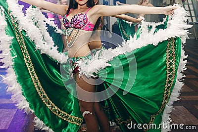 Sexy exotic belly dancers in traditional clothes with silk skirts performing at dance hall event in restaurant, beautiful woman Editorial Stock Photo