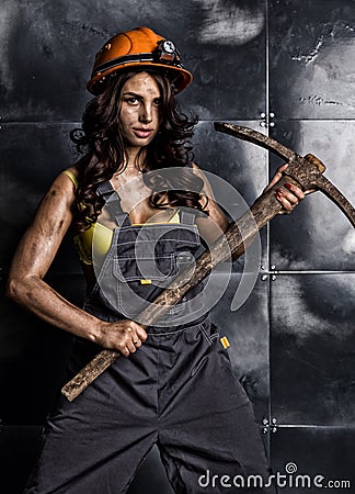 female miner worker with pickaxe, in coveralls over his naked body Stock Photo