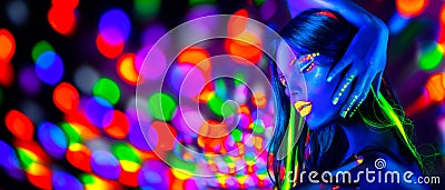 Sexy girl dancing in neon lights. Fashion model woman with fluorescent makeup posing in UV Stock Photo