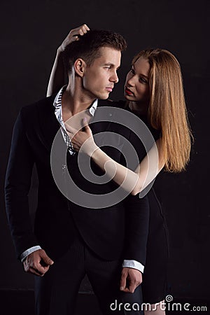 A sexy girl during a passionate embrace clung to the hair of her man Stock Photo