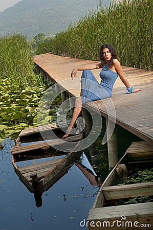Sexy Girl Sitting On A Pier Royalty Free Stock Photography 