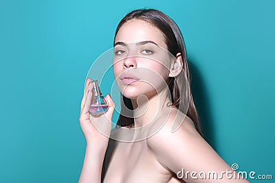 Sexy girl using parfume. Young beautiful woman with a bottle of perfume. Model with healthy skin, close up beauty Stock Photo